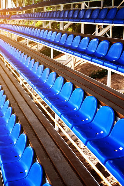 スポーツ競技場の青いプラスチックシート。サッカー場の椅子だ。アリーナ - 写真・画像
