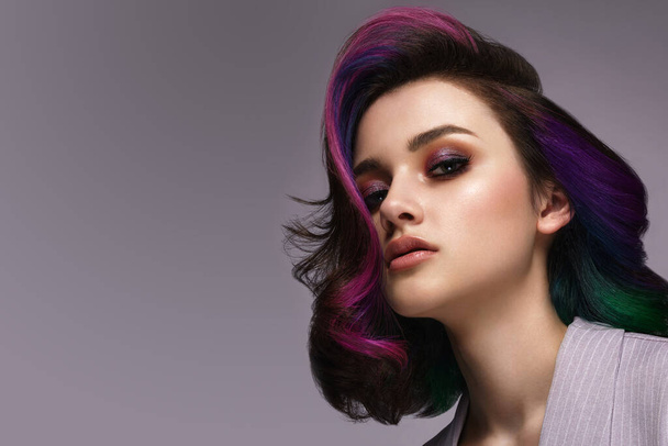 Beautiful woman with multi-colored hair and classic make up and hairstyle. Beauty face. - Фото, изображение