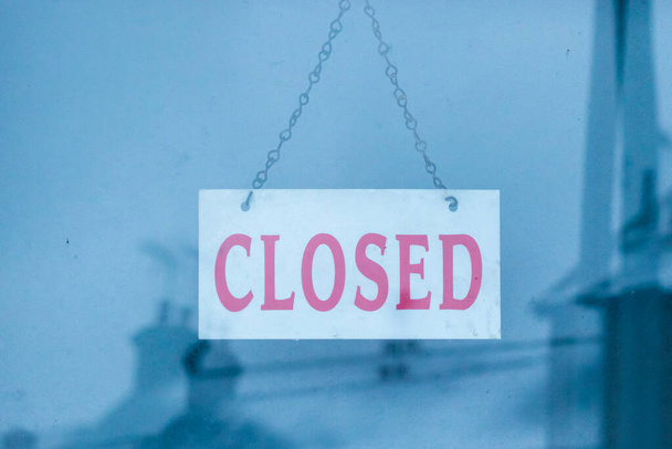 Closed sign in a shop window on a cold winters day - Photo, Image