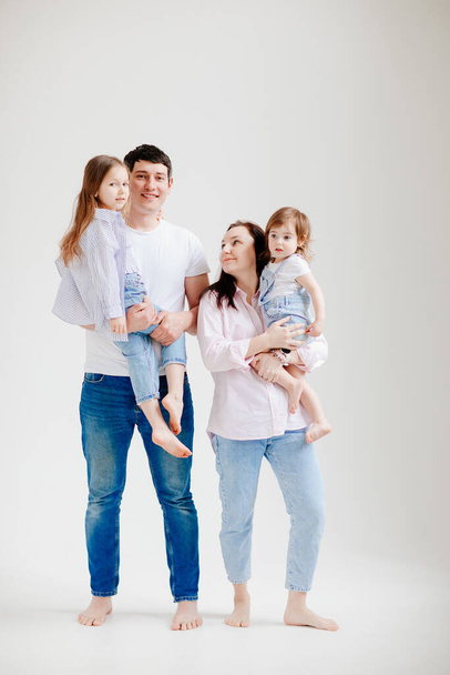 beautiful happy family at a photo shoot in a white photo studio. backstage. - 写真・画像
