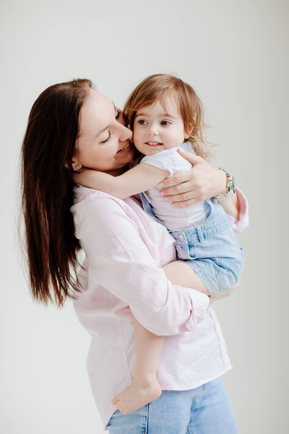 beautiful happy family. Mom and daughter cuddling - 写真・画像