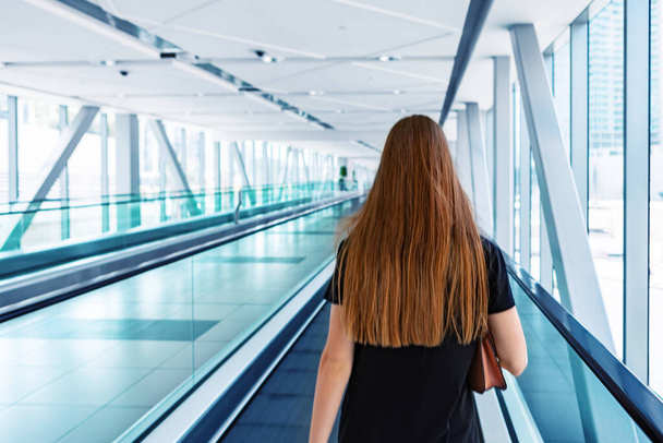 Young woman standing at the escalator in subway - Foto, Bild