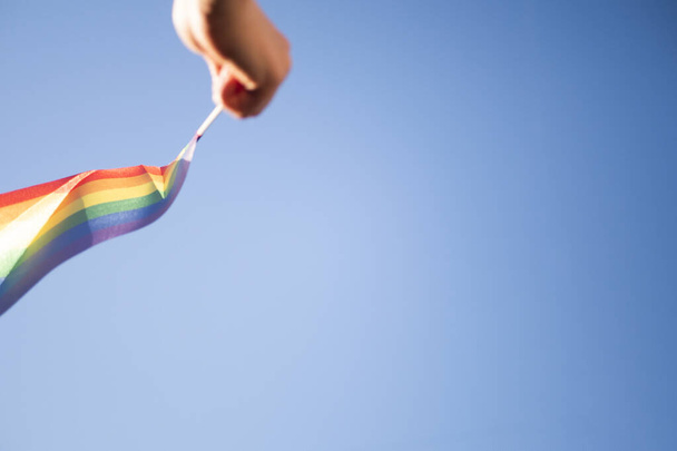 Hand holding rainbow flag. Copy space. Pride month celebration  - Photo, Image