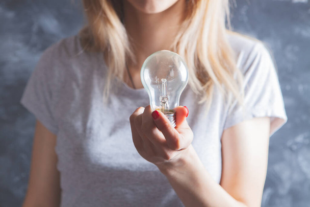 girl holding a light bulb - Zdjęcie, obraz