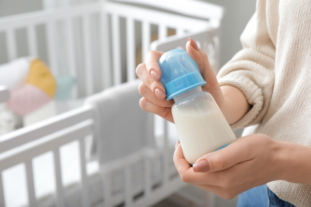 Woman with bottle of milk for baby, closeup - Photo, Image