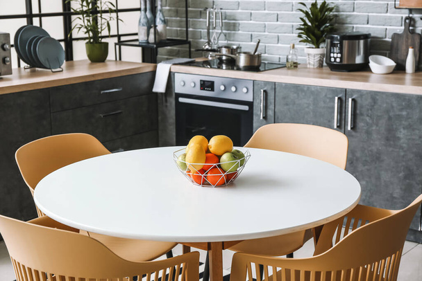 Тарелка с фруктами на столе на кухне - Фото, изображение