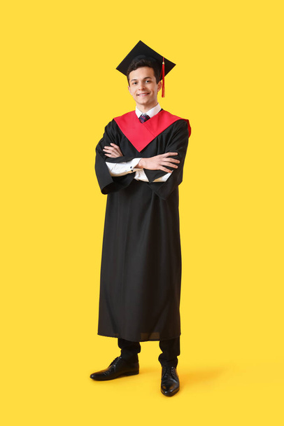 Male graduating student on color background - Photo, image