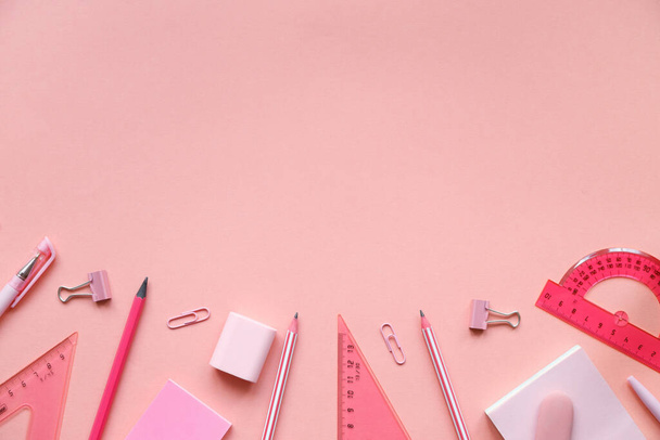 Stationary concept, Flat Lay top view Photo of school supplies scissors, pencils, paper clips,calculator,sticky note,stapler and notepad in pastel tone on pink background with copy space. - Фото, зображення