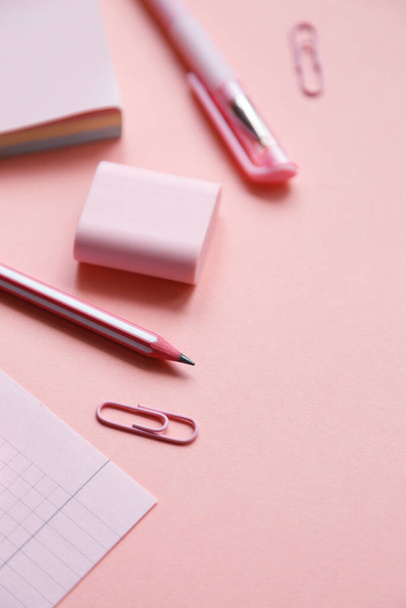 Stationary concept, Flat Lay top view Photo of school supplies scissors, pencils, paper clips,calculator,sticky note,stapler and notepad in pastel tone on pink background with copy space. - Photo, Image