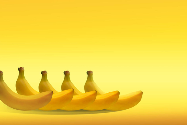 Illustration, composition of yellow bananas on a colored background. Healthy lifestyle. - Photo, Image