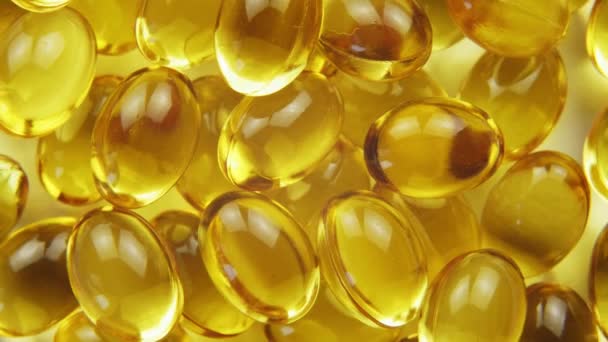 Top down view omega 3 gold fish oil capsules, rotation background, macro - Footage, Video