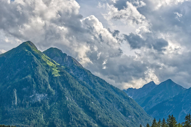 A closeup shot of mountains under a cloudy sky in the Alps, Austria - Fotoğraf, Görsel