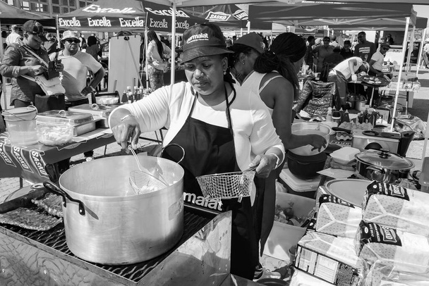 JOHANNESBURG, SOUTH AFRICA - Jan 05, 2021: Soweto, South Africa - September 8, 2018: Diverse African vendors cooking and serving various bread based street food at outdoor festival - Photo, Image