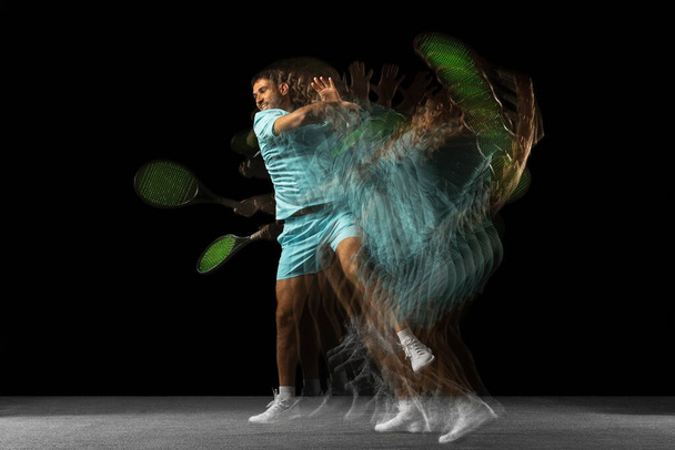Stroboscope effect. One man, professional tennis player isolated on black background in mixed neon light. - Photo, Image