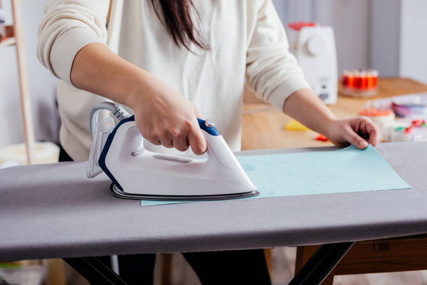 Process of ironing textile before cutting the pattern and sewing - 写真・画像