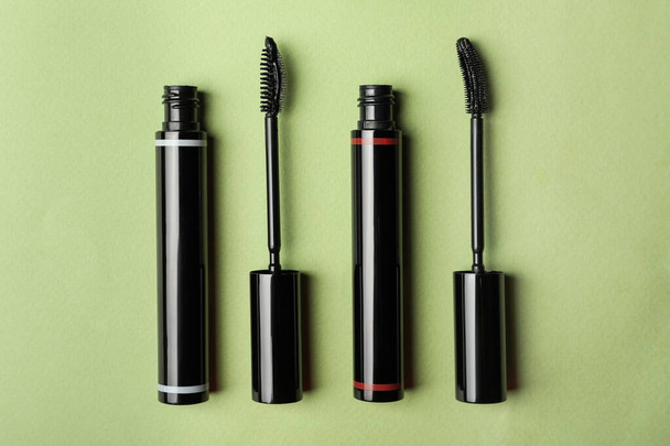 Different mascaras for eyelashes on light background, flat lay. Makeup product - Fotó, kép