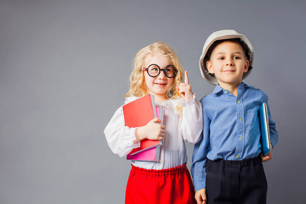 The little couple in costumes of teacher and engineer - Фото, изображение