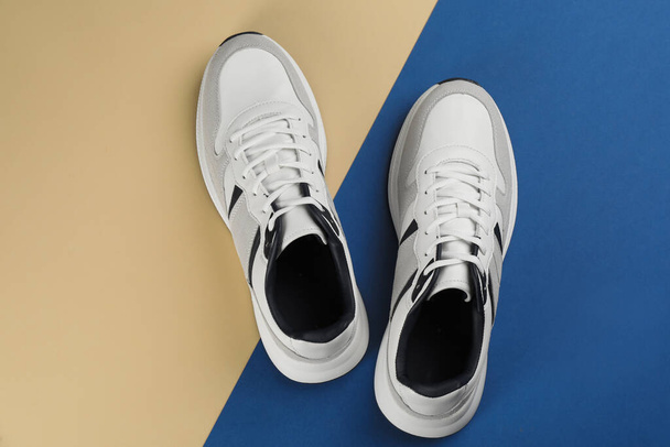 Pair of stylish sneakers on color background, flat lay - Photo, Image