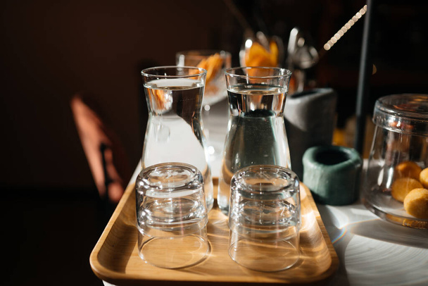 Four glass cups on the bar counter with serving accessories. - Foto, Imagem