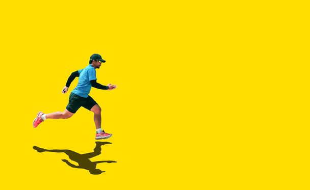 Asian man in blue shirt running on colored background With clipping path - Photo, Image