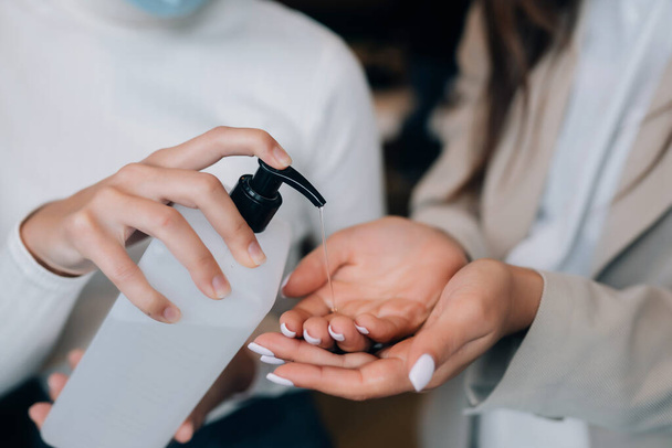 Female hands applying antibacterial liquid soap close up. - Photo, Image