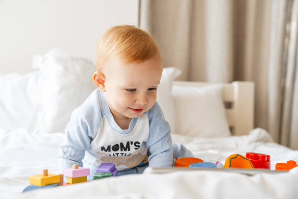 Happy smiling little baby boy playing on bed - Photo, image