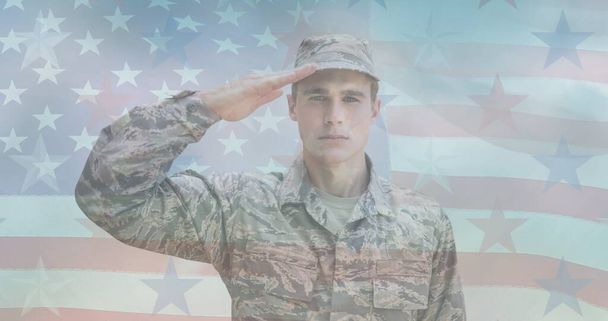 Composition of male soldier saluting over american flag. patriotism and celebration concept digitally generated image. - Foto, Bild