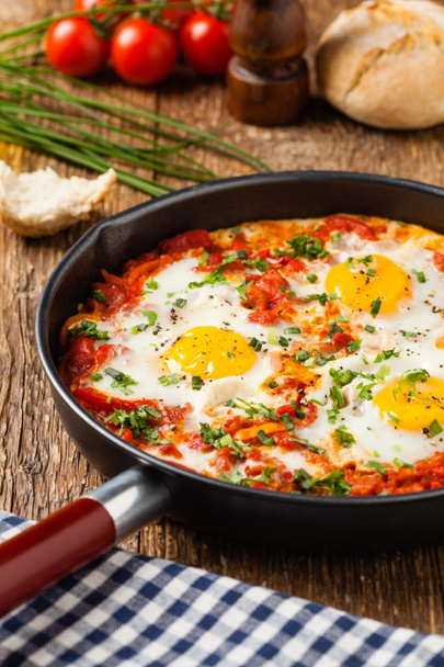 Shakshouka, dish of eggs poached in a sauce of tomatoes, chili peppers, onions. Front view.  - Foto, immagini