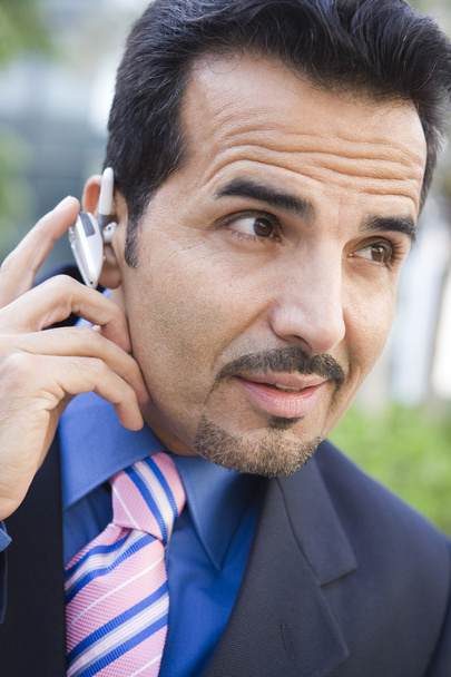 Businessman using bluetooth earpiece - Photo, Image