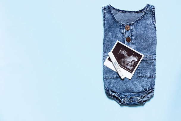 top view of baby clothes and accessories on blue background - Φωτογραφία, εικόνα