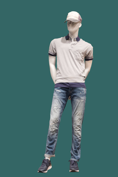 Full length image of a male display mannequin wearing casual clothes isolated on a green background. - Photo, Image