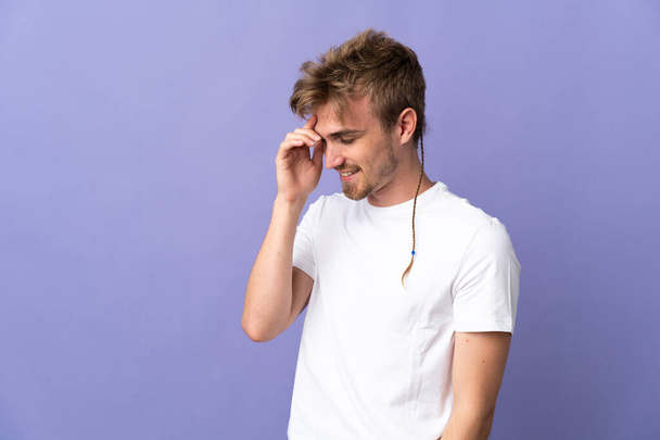 Young handsome blonde man isolated on purple background laughing - Foto, afbeelding
