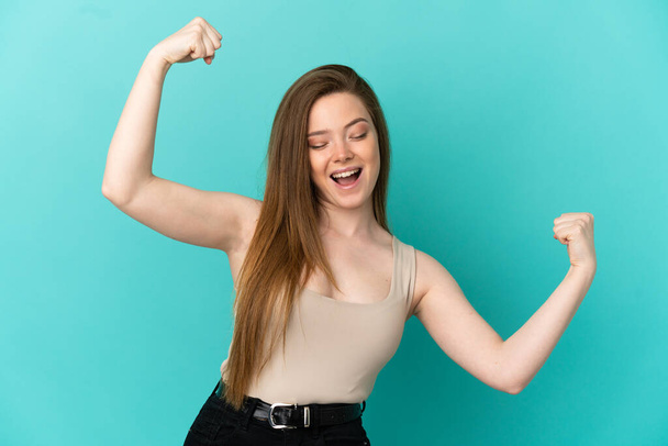 Teenager girl over isolated blue background celebrating a victory - Photo, image