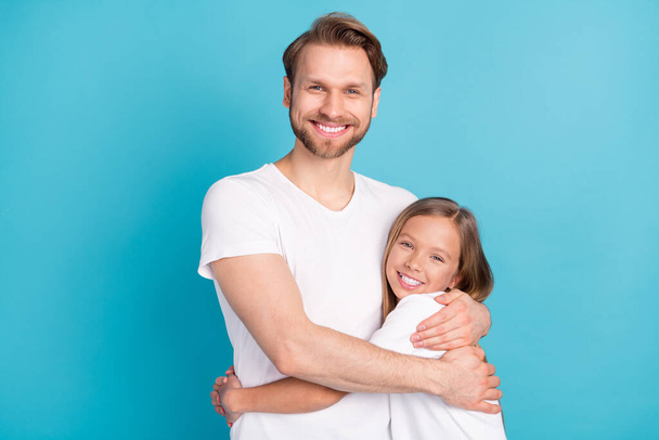 Portrait of positive guy cute pupil girl hugging toothy smile look camera isolated on blue color background - Foto, immagini