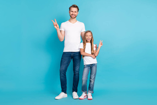 Full size portrait of handsome guy cute girl standing fingers show v-sign isolated on blue color background - Photo, Image