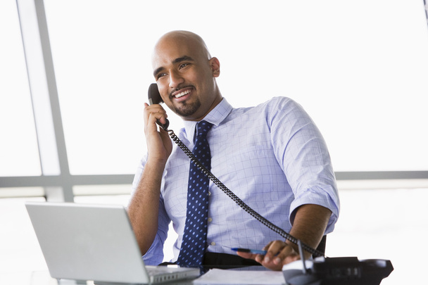 Businessman talking on phone in office - Photo, Image