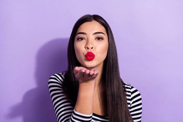 Photo of young pretty good looking beautiful girl send you air kiss wear striped sweater isolated on violet color background - Φωτογραφία, εικόνα