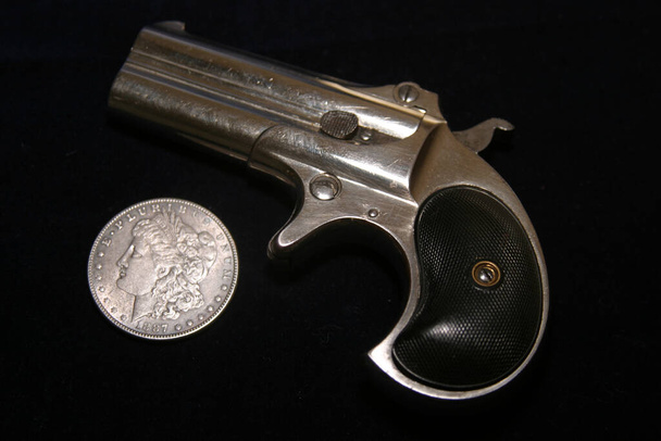 Genuine Antique 1887 Double Derringer Pocket Pistol. Isolated on white with room for your text or information. Circa 1889, Model 95, Type II Model 3 Double Derringer on card table with aces and eights aka a Dead Mans Hand. Dead Mans Hand.  - Photo, Image