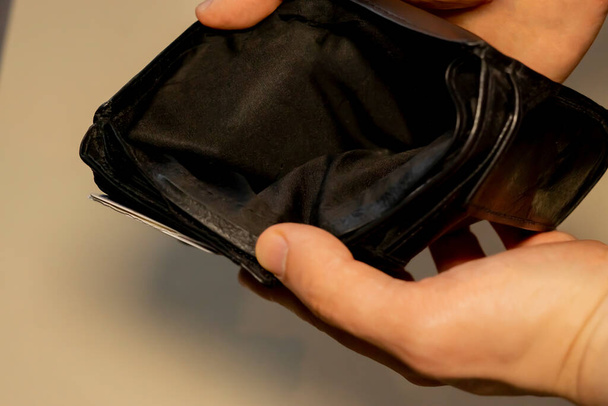 hand holding a wallet with no money. Empty wallet. Poor. unemployed. - Photo, Image