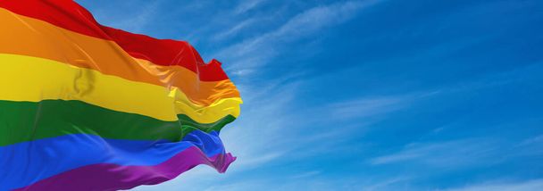 Gay Pride flag waving in the wind at cloudy sky. Freedom and love concept. Pride month. activism, community and freedom Concept. Copy space. 3d illustration, - Foto, Imagem