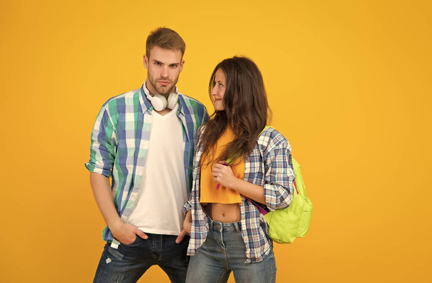 Millennial couple of sexy woman looking with love on handsome man in casual fashion style yellow background, modern - Фото, изображение