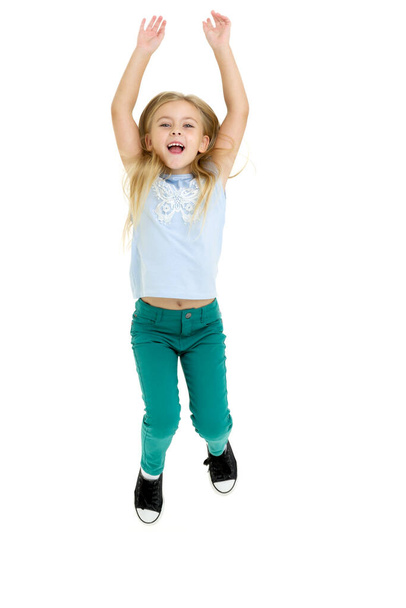 Happy girl jumping with raising hands - Foto, afbeelding