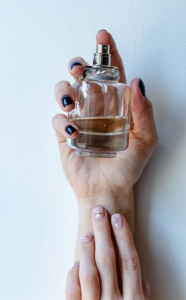 women's hands with manicure and perfume - 写真・画像