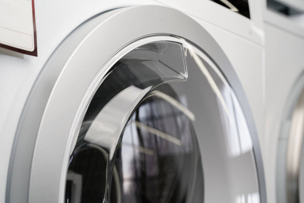 New washing machine in a home appliances store - Фото, изображение