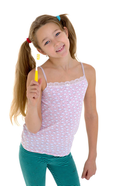 Smiling girl standing with toothbrush - 写真・画像