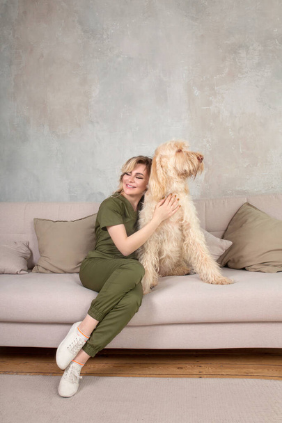 Beautiful Young Doctor With Her Dog In The Room - Foto, Bild