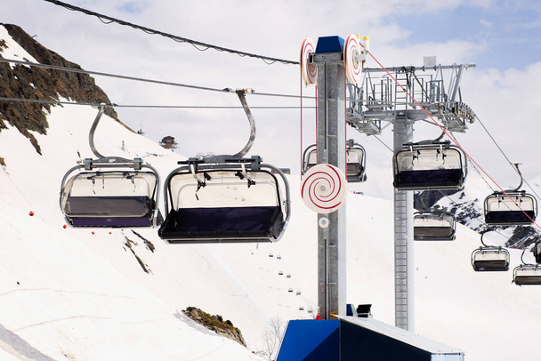 Open air ski lift going to the top of the mountain for alpine skiing. - Photo, Image