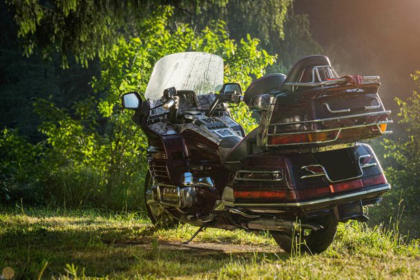 Japanese motorcycle Honda GoldWing. Motorcycle parked outside in the forest. Beautiful machine - Photo, Image