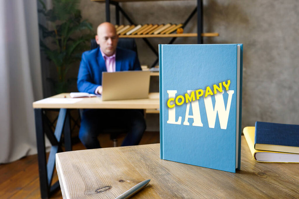  COMPANY LAW inscription on the sheet. Corporate law is the body of law governing the rights, relations, and conduct of persons, companies, organizations and businesse - Фото, зображення
