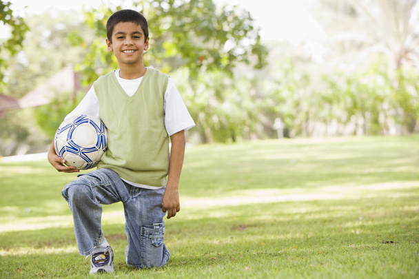 Boy in park holding football - Fotografie, Obrázek